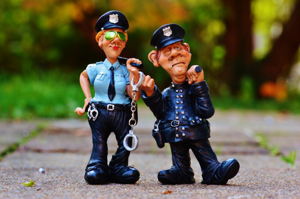 A pair of funny police officer figurines on the ground