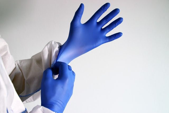 A sanitation work wearing gloves to do the job