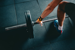A person picking up weight in the gym for strength training