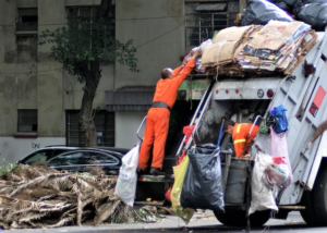 The sanitation workers using the garbage truck