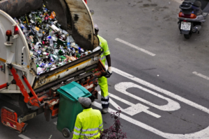 Sanitation worker hauling trash