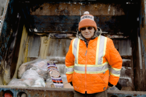 Sanitation worker hauling trash