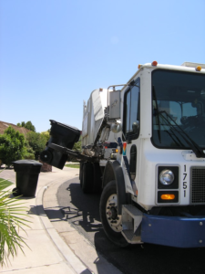 A garbage disposal truck picking up the trash
