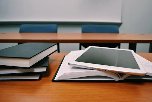 Books and a tablet on a desk