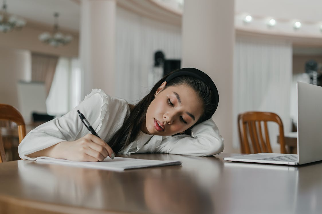 A person writing on a paper